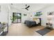 Primary bedroom featuring hardwood floors, modern ceiling fan, and sliding glass doors to a balcony at 3817 W San Nicholas St, Tampa, FL 33629