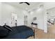 Contemporary bedroom featuring hardwood floors, a stylish black bed, and modern lighting, blending comfort and sophistication at 3817 W San Nicholas St, Tampa, FL 33629
