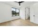 Bright bedroom features a black ceiling fan, light wood floors, and an en suite bathroom for convenience at 3817 W San Nicholas St, Tampa, FL 33629