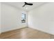 Simple bedroom featuring light wood floors, neutral walls, and a modern window for a clean and serene feel at 3817 W San Nicholas St, Tampa, FL 33629