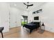 Bright bedroom with hardwood floors, a metal bed frame, and a large window showcasing the backyard at 3817 W San Nicholas St, Tampa, FL 33629