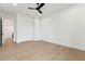 Spacious bedroom with light wood floors, white walls, closet, and a modern ceiling fan at 3817 W San Nicholas St, Tampa, FL 33629