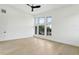 Airy bedroom with large windows, a ceiling fan, and light wood floors, providing a comfortable and bright space at 3817 W San Nicholas St, Tampa, FL 33629
