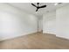 Bedroom featuring light wood floors, white walls, closet, and a modern ceiling fan at 3817 W San Nicholas St, Tampa, FL 33629