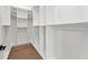 Spacious walk-in closet with custom shelving and wooden floors, providing ample storage and organization at 3817 W San Nicholas St, Tampa, FL 33629
