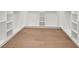 Walk-in closet with light hardwood floor and white shelving at 3817 W San Nicholas St, Tampa, FL 33629