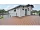 Exterior view of the home's large wooden deck with metal railing and sliding glass doors for indoor/outdoor living at 3817 W San Nicholas St, Tampa, FL 33629