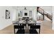 Elegant dining area with modern decor, connecting living space with open staircase, perfect for hosting gatherings at 3817 W San Nicholas St, Tampa, FL 33629