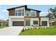 Modern two-story home boasts a contemporary design with a well-manicured lawn and a spacious two-car garage at 3817 W San Nicholas St, Tampa, FL 33629