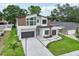 Stunning modern home with two-car garage, contemporary entrance, and manicured lawn enhanced by patterned concrete at 3817 W San Nicholas St, Tampa, FL 33629