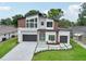 Striking modern exterior with a well-manicured lawn and unique landscaping that enhances the home's curb appeal at 3817 W San Nicholas St, Tampa, FL 33629