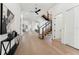 Open-concept foyer features a floating staircase, light wood floors, and leads to other areas of the house at 3817 W San Nicholas St, Tampa, FL 33629
