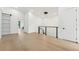 Bright hallway with light wood floors and modern lighting fixture, offering a clean and spacious feel at 3817 W San Nicholas St, Tampa, FL 33629