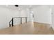 Open hallway with modern lighting fixture and railing detail leading to bedrooms at 3817 W San Nicholas St, Tampa, FL 33629