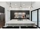 Sleek kitchen featuring quartz countertops, stainless steel appliances, and access to the outdoor area at 3817 W San Nicholas St, Tampa, FL 33629
