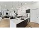 Open-concept kitchen with island, modern appliances, and seamless flow into the dining and living areas at 3817 W San Nicholas St, Tampa, FL 33629