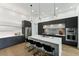 Modern kitchen island with quartz countertops, stainless steel appliances and pendant lighting at 3817 W San Nicholas St, Tampa, FL 33629