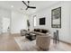 Comfortable living room featuring a plush sofa, two armchairs, and large windows that bring in natural light at 3817 W San Nicholas St, Tampa, FL 33629