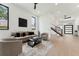 Spacious living room with light wood floors, floating staircase, and modern decor for a comfortable and inviting space at 3817 W San Nicholas St, Tampa, FL 33629
