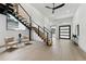 Contemporary living room showcases an open staircase, light wood floors, and modern decor for a stylish ambiance at 3817 W San Nicholas St, Tampa, FL 33629