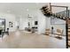 Bright and airy living room boasts an open layout with floating stairs, light wood floors, and minimalist decor at 3817 W San Nicholas St, Tampa, FL 33629
