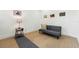 Living room showcasing gray futon with accent pillows, a rug, and a side table at 3817 W San Nicholas St, Tampa, FL 33629