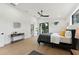Bright, modern primary bedroom with hardwood floors and balcony access at 3817 W San Nicholas St, Tampa, FL 33629
