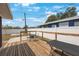 Cozy backyard deck area featuring a wooden deck, seating area, and white privacy fence at 4558 23Rd N Ave, St Petersburg, FL 33713