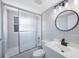 Bathroom with shower and bath, updated vanity and round mirror at 4558 23Rd N Ave, St Petersburg, FL 33713