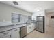 Stylish kitchen featuring stainless steel appliances, white cabinets, and a granite countertop at 4558 23Rd N Ave, St Petersburg, FL 33713