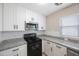 Contemporary kitchen with granite countertops, white cabinets, and stainless appliances at 4558 23Rd N Ave, St Petersburg, FL 33713