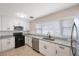 Updated kitchen features white cabinets, stainless steel appliances, granite countertops, and modern fixtures at 4558 23Rd N Ave, St Petersburg, FL 33713