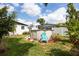 Backyard featuring an above ground pool, shed, palm trees, and seating area at 4601 83Rd N Ave, Pinellas Park, FL 33781