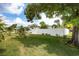 Spacious backyard featuring lush green grass and a white privacy fence, perfect for outdoor activities at 4601 83Rd N Ave, Pinellas Park, FL 33781