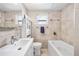 Bright bathroom featuring a sleek vanity, tiled walls, and a tub with a jacuzzi jet system at 4601 83Rd N Ave, Pinellas Park, FL 33781