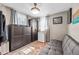 Small bedroom featuring two windows, closet with black doors, sofa, and a rug at 4601 83Rd N Ave, Pinellas Park, FL 33781