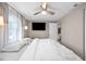 Bedroom features a ceiling fan, window, wall-mounted TV, and doorway to another room at 4601 83Rd N Ave, Pinellas Park, FL 33781