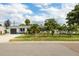 Charming single-story home with a well-manicured lawn and lush palm trees enhancing its curb appeal at 4601 83Rd N Ave, Pinellas Park, FL 33781