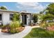 Welcoming front entrance with a landscaped walkway, decorative plants, and an inviting front door at 4601 83Rd N Ave, Pinellas Park, FL 33781