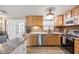 Kitchen with wood cabinets, stone countertops, stainless appliances, and access to bedroom at 4601 83Rd N Ave, Pinellas Park, FL 33781
