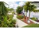 Well-maintained landscaping along the walkway with lush plants, flowers, and decorative accents at 4601 83Rd N Ave, Pinellas Park, FL 33781