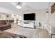 Inviting living room featuring a large television, comfortable leather seating, and light, neutral decor at 4601 83Rd N Ave, Pinellas Park, FL 33781