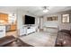 Open living area with kitchen view featuring comfortable leather seating, a large TV, and stylish decor at 4601 83Rd N Ave, Pinellas Park, FL 33781