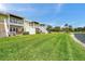 Beautiful backyard featuring green grass and white stairs leading to the multiple townhomes at 4734 Cobia Se Dr # A, St Petersburg, FL 33705