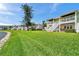 The backyard has green grass and white stairs leading to the multiple townhomes at 4734 Cobia Se Dr # A, St Petersburg, FL 33705