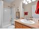 Bright bathroom with a shower-tub combo, modern vanity, and neutral wall color at 4734 Cobia Se Dr # A, St Petersburg, FL 33705