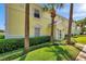 Charming yellow condo with well-manicured landscaping and tropical palm trees enhancing curb appeal at 4734 Cobia Se Dr # A, St Petersburg, FL 33705