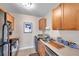 Well-lit kitchen with wood cabinets, stainless steel sink, and essential appliances for convenient cooking at 4734 Cobia Se Dr # A, St Petersburg, FL 33705