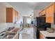 This kitchen has wood cabinets and is connected to other rooms in the home, maximizing space and connectivity at 4734 Cobia Se Dr # A, St Petersburg, FL 33705