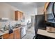 This kitchen has wood cabinets and is connected to other rooms in the home, maximizing space and connectivity at 4734 Cobia Se Dr # A, St Petersburg, FL 33705